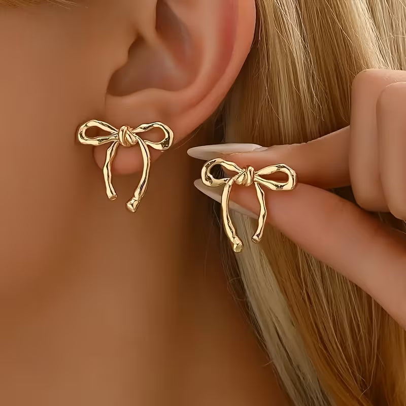 Elegante vintage goldene Schleifenohrringe